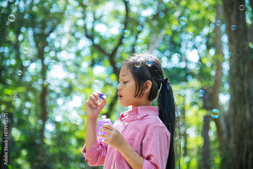 Wallpaper Mural Adorable happy cute girl playful foam bubbles in green playground in summer outdoors. Funny Cheerful girl in the park with happy times. Torontodigital.ca