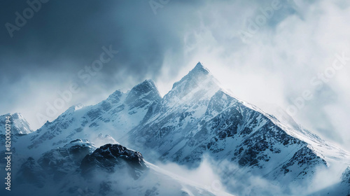 snowy mountain peaks. Majestic snowy mountain peaks shrouded in mist, creating a dramatic and awe-inspiring landscape.