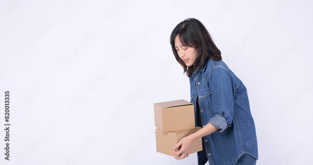 young asian woman wearing orange t-shirt and denim shirt holding parcel box isolated on white studio background, Delivery courier and shipping service concept. young asian woman wearing orange t-shirt and denim shirt holding parcel box isolated on white studio background, Delivery courier and shipping service concept.