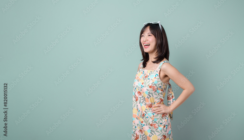Happy Asian woman with casual dress isolated on pastel green background