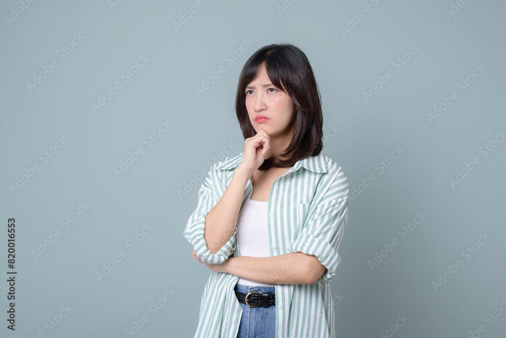 Lifestyle, asian woman emotions and casual concept. Shy and modest cute clueless girl, smirk, uncertain, having doubts or hesitations, standing pastel green background Lifestyle, asian woman emotions and casual concept. Shy and modest cute clueless girl, smirk, uncertain, having doubts or hesitations, standing pastel green background