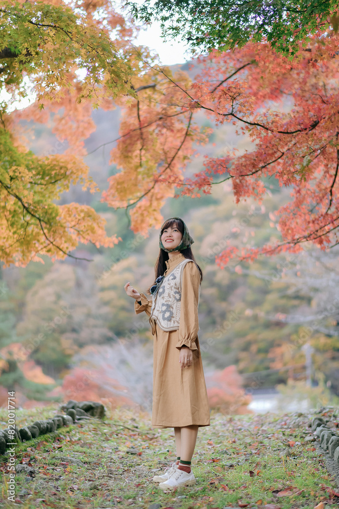 Asian woman in casual dress embraces the fall beauty of Japan, enjoying a holiday filled with smiles, fashion, and vibrant foliage. A cheerful portrait capturing the essence of a vacation. Asian woman in casual dress embraces the fall beauty of Japan, enjoying a holiday filled with smiles, fashion, and vibrant foliage. A cheerful portrait capturing the essence of a vacation.