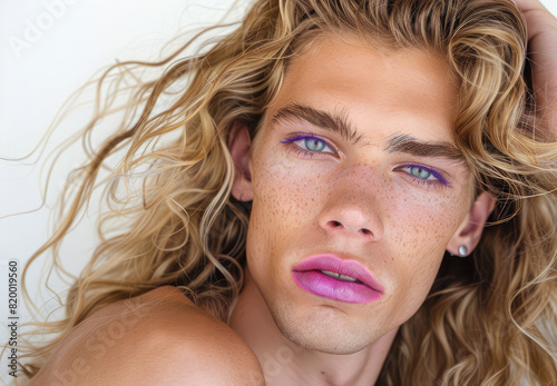 Portrait of a blond androgynous man with make-up