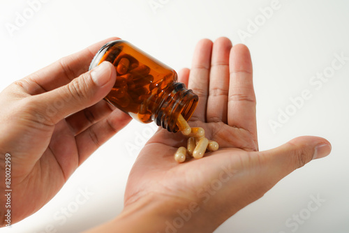 man pouring pills into hand white background