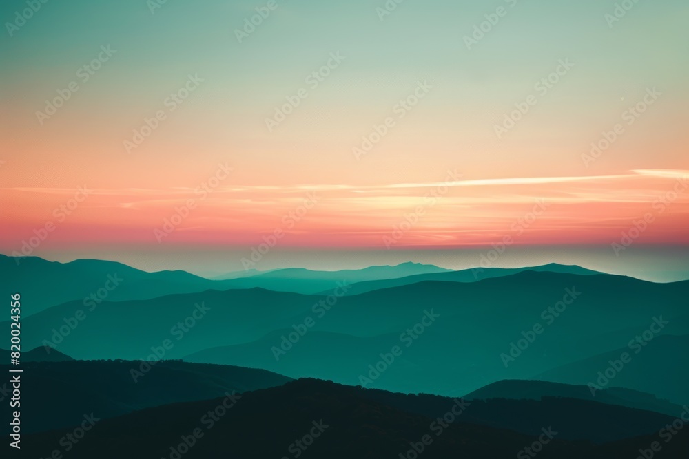 Serene landscape with mountain ranges at sunset, showcasing vibrant hues and tranquil scenery perfect for nature and travel themes.