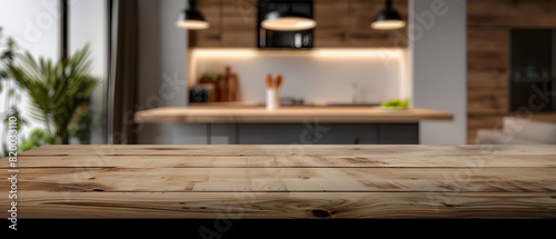 A defocused image of a contemporary kitchen  showcasing the wooden countertop as the foreground