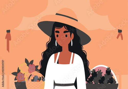 A woman wearing a straw hat is standing in front of a table with flowers