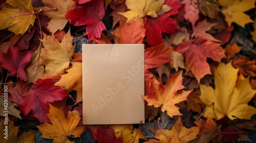 Empty note with a backdrop of vibrant red and yellow fall leaves, ready for seasonal messages