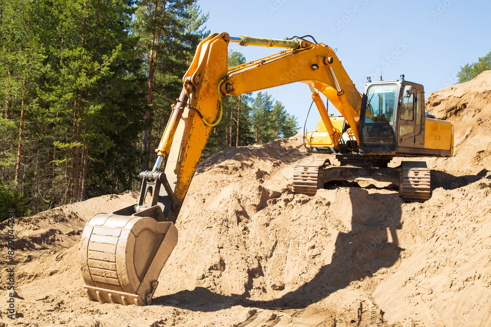 The excavator is working in a sand loading quarry. The excavator is working in a sand loading quarry.