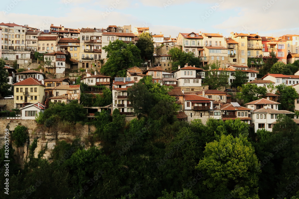 Beautiful view onto one of the neighborhoods of the old town of Veliko Tarnovo, rising above a dense forest, Veliko Tarnovo, Bulgaria Beautiful view onto one of the neighborhoods of the old town of Veliko Tarnovo, rising above a dense forest, Veliko Tarnovo, Bulgaria