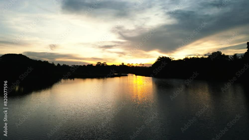 beautiful lake during sunset time ; peaceful water and lake during sunrise beautiful lake during sunset time ; peaceful water and lake during sunrise