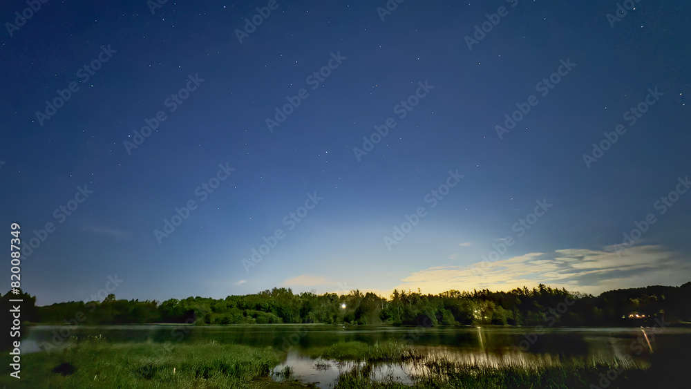 A star filled night sky over a river A star filled night sky over a river