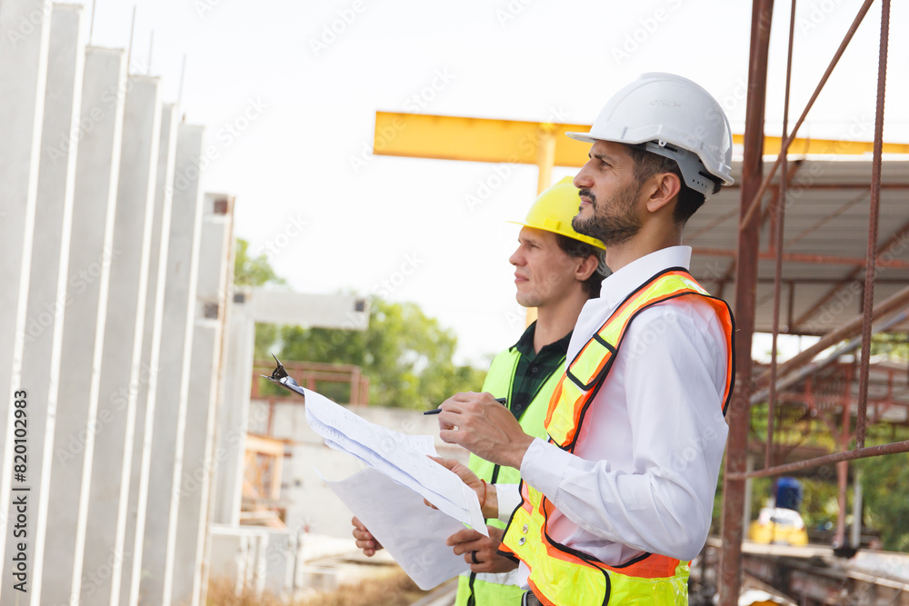 Engineer team discuss and examine a building construction. Engineer team discuss and examine a building construction.
