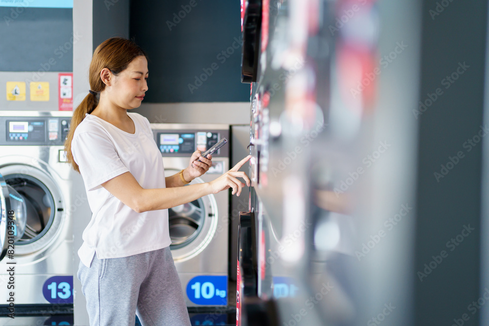 Woman washing clothes at washing KIOSK vendor. Woman washing clothes at washing KIOSK vendor.