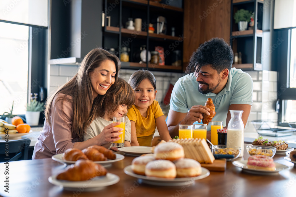 Portrait of happy family having breakfast at home. Portrait of happy family having breakfast at home.