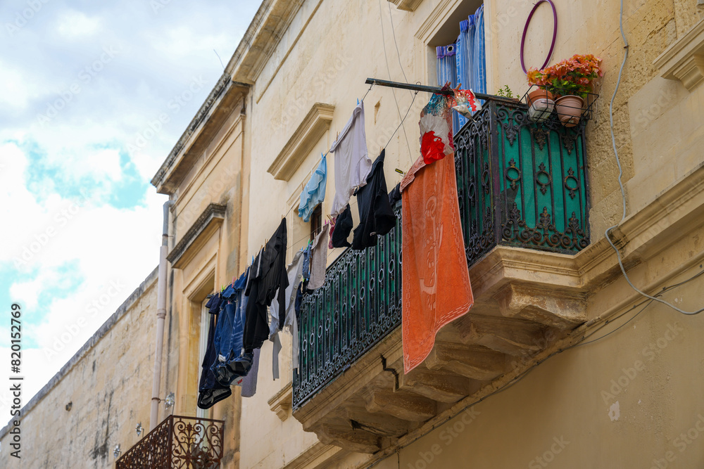 Fototapeta premium Colorful Laundry drying in the the golden historic center of Lecce Italy