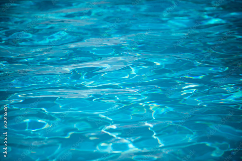 Water background, ripple waves. Blue swiming pool pattern. Sea surface. Water in swimming pool with sun reflection. Banner with copy space. Water background, ripple waves. Blue swiming pool pattern. Sea surface. Water in swimming pool with sun reflection. Banner with copy space.