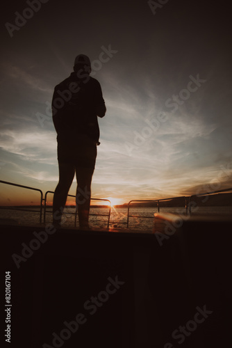 Silhouette of Man at Sunset on the Boat