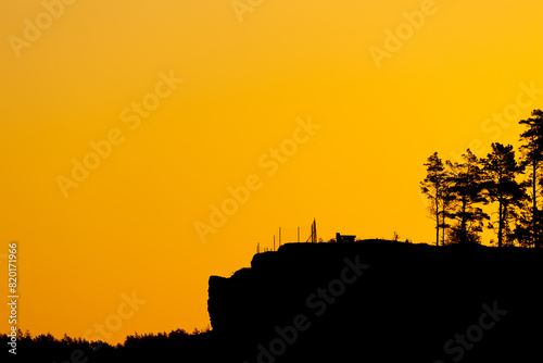 Golden orange sunrise and hill tree silhouette