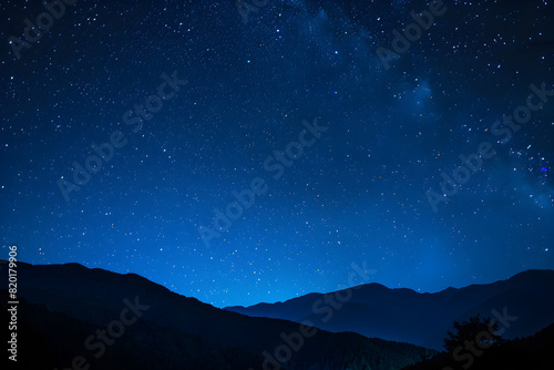 A breathtaking view of a starry night sky with mountains in the background  creating a serene and tranquil atmosphere.