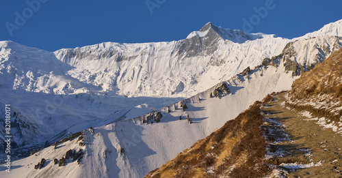 Mount Khangsar Kang or also Rock Noir, seen over the Tilicho Lake trail, Annapurna Conservation Area, Himalaya, Nepal. Annapurna Circuit trail. Sunrise over a mountain range. photo