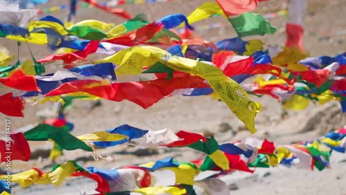 Slow motion shot of Buddhist prayer flags waving in the strong wind at Kunzum Pass on way to Spiti Valley in Himachal Pradesh, India. Prayer flags moving rapidly due to the extreme stormy winds.