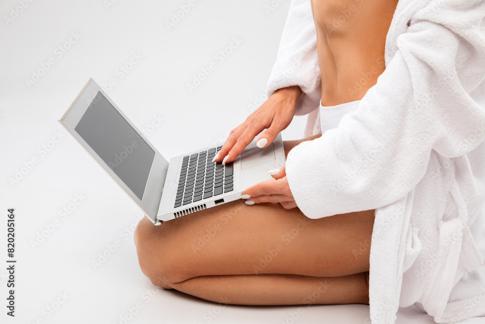 Obraz premium Slender dark-skinned woman blogger in white underwear and a dressing gown on a white background. Healthy lifestyle, sports and diet.