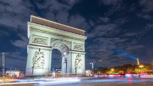 4K Timelapse of traffic at Arc de Triomph at night. This historical monument overlooks the avenue des champs élysées in the heart of Paris, French capital.