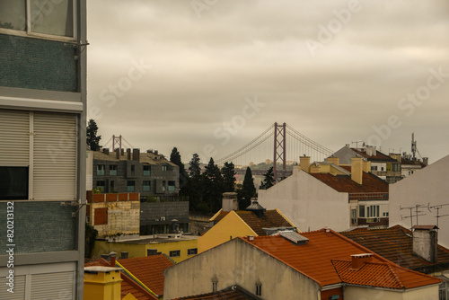 Overview of a low-rise neighborhood in Lisbon, Portugal. Vasco da Gama Bridge in the background.