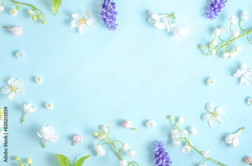 Flat lay frame from spring flowers on a light blue background. View from above, copy space. Beautiful floral frame. Springtime. aesthetics photo