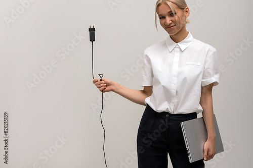cheerful young beautiful blonde woman with laptop in her hands in studio