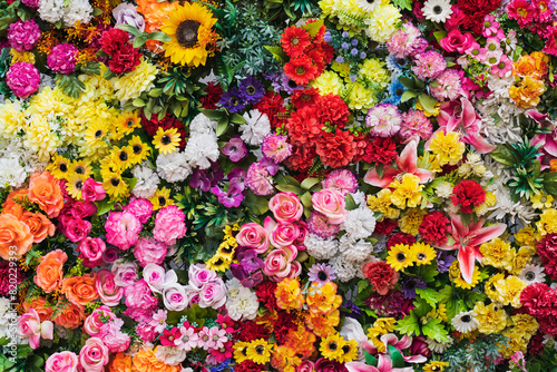 Photo background texture, wall of artificial flowers, photo wallpaper close-up.