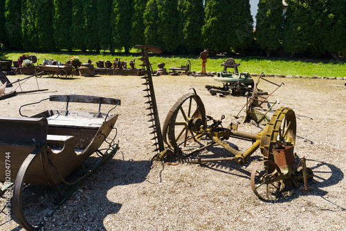 Farm Implements Resting on Dirt Field