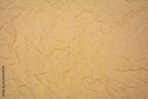 Beige color background with dense wrinkles. Beige color recycled kraft paper texture as background.
