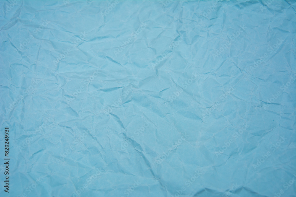 Light blue background with dense wrinkles. Light blue color recycled kraft paper texture as background.