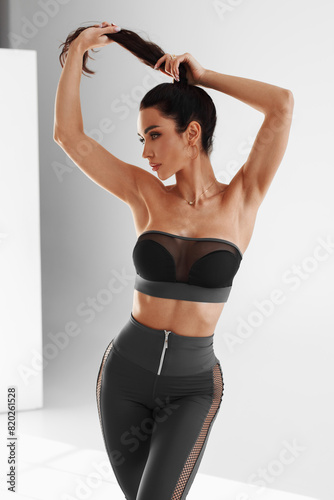 Fitness woman. Athletic girl on the gray background