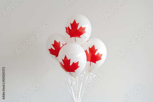 White Balloons with Red Maple Leafs Design against a Neutral Background
