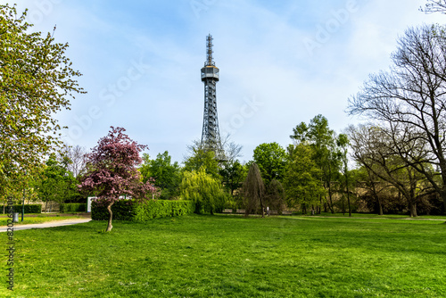 Prague, Czech Republic - April 14, 2023: Petrin observation tower in Prague located in a park among trees on a hill above the city.