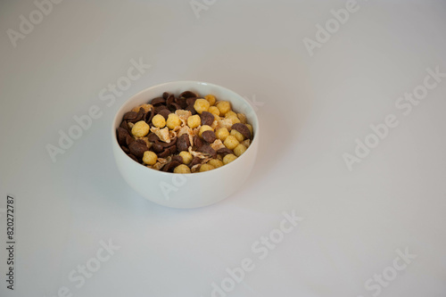 A bowl of mixed brown and yellow corn falkes photo