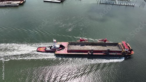 Aerial view of a dredge ship being pushed by a tugboat down the Raritan River in Perth Amboy, New Jersey