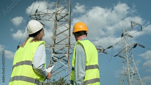 Team of power line inspectors conducting audit of transmission towers © Nataliya