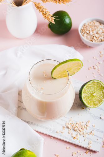 Oatzempic trendy drink for weight loss made from oatmeal, water and lime in a glass vertical view