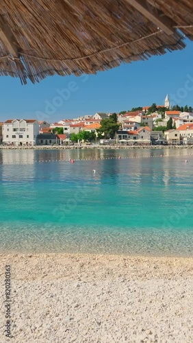 Idyllic beach near the charming Primosten town, Adriatic Sea in Croatia. A perfect summer holidays travel destination.