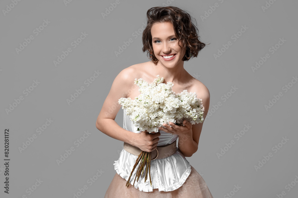 Happy young woman with bouquet of blooming white lilac flowers on grey background Happy young woman with bouquet of blooming white lilac flowers on grey background