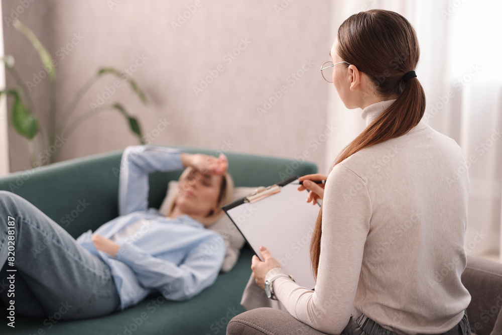 Professional psychotherapist working with patient in office Professional psychotherapist working with patient in office