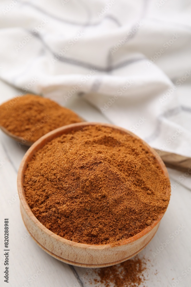 Aromatic spice. Ground red pepper in bowl and spoon on white wooden table, closeup Aromatic spice. Ground red pepper in bowl and spoon on white wooden table, closeup