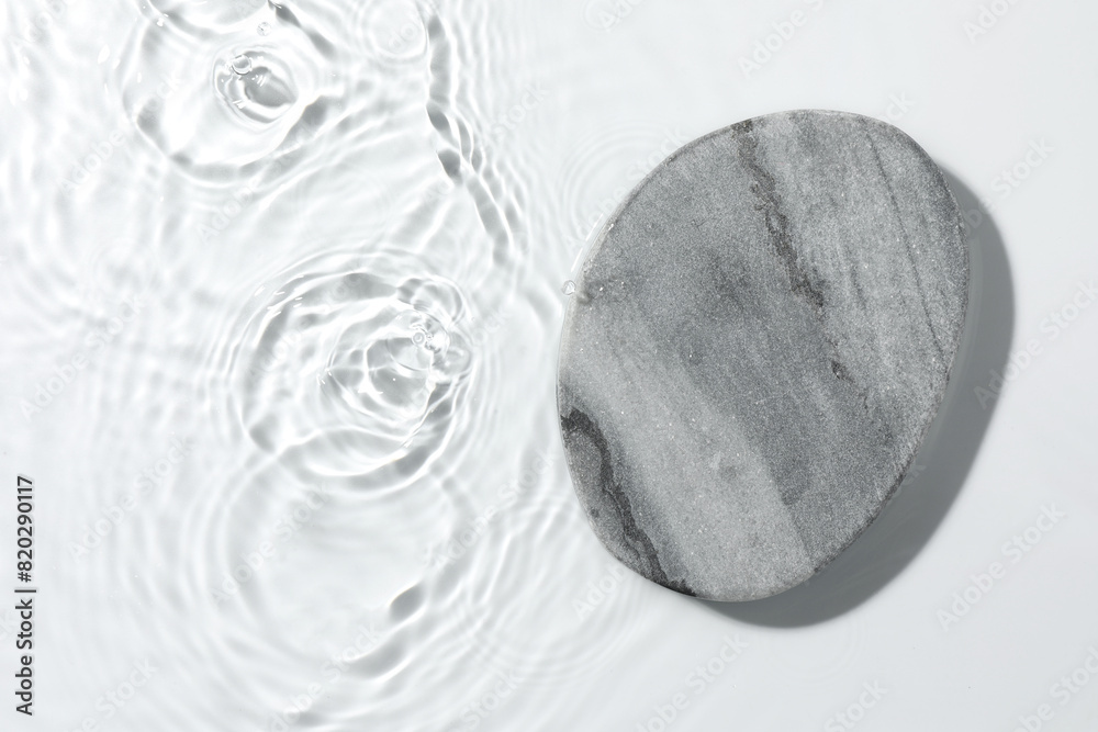 Presentation of product. Stone podium in water on white background, top view. Space for text Presentation of product. Stone podium in water on white background, top view. Space for text