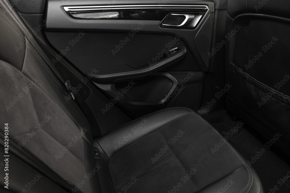 Leather seat inside of modern black car, closeup