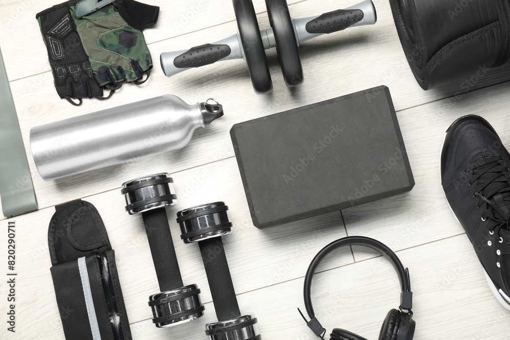 Different sports equipment on white wooden table, flat lay Different sports equipment on white wooden table, flat lay