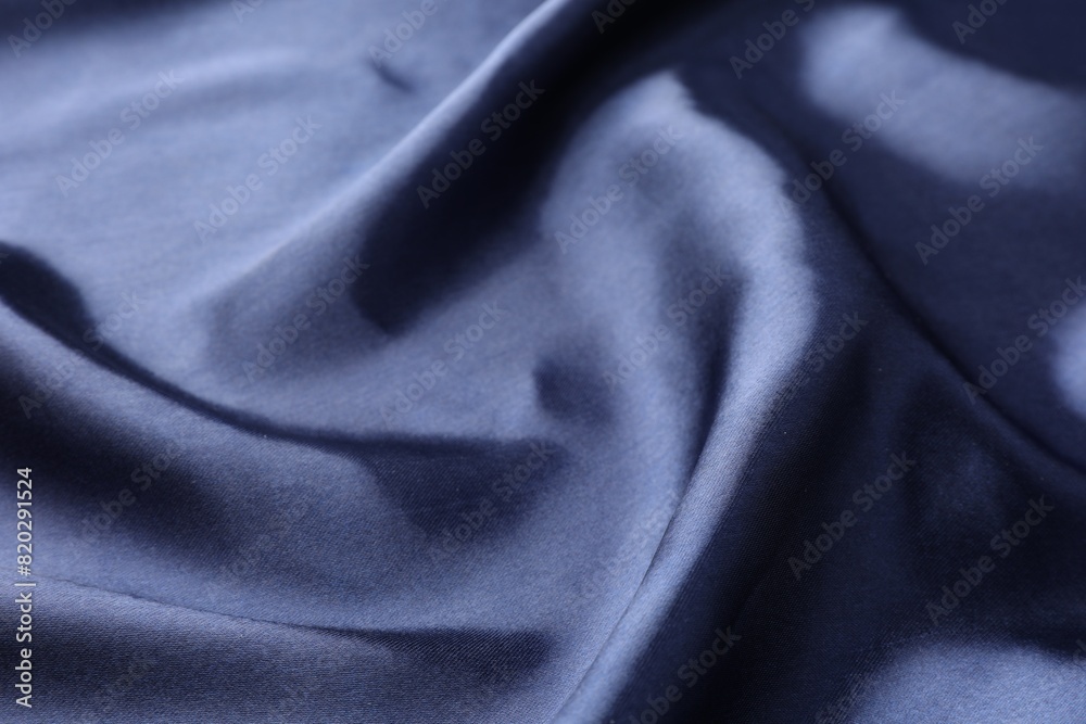 Fototapeta premium Crumpled dark blue silk fabric as background, closeup